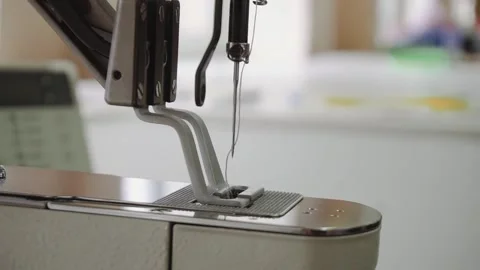 Needle with thread on modern special sewing machine at plant Stock Footage 236907765