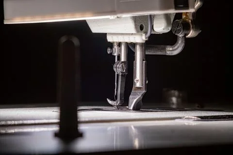 The needle with thread in the sewing machine. Stock Photos