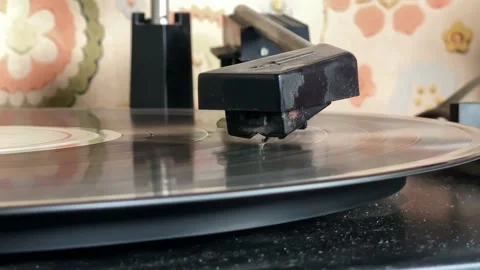 The needle of a turntable playing the tracks of a black vinyl record. Stock Footage 165065570