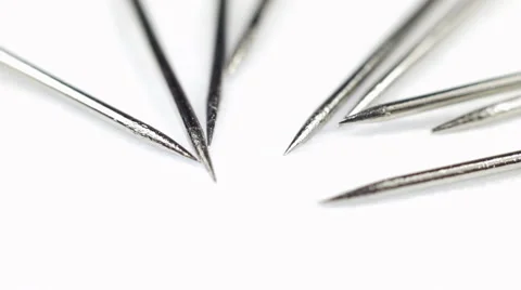 Needles rotating on white background Stock Footage 40479795