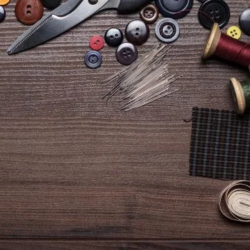 Needles threads and buttons on the table Stock Photos