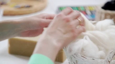 Needlewoman inserts needles into wool to give the desired form. Stock-Footage 79407408