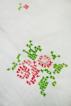 Needlework embroidered floral pattern on white cloth Stock Photos