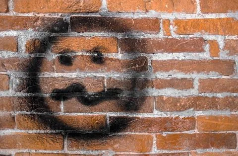 Needy face on wall Stock Photos