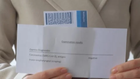 Negative corona virus test in the hands of a girl Stock Footage 152488352