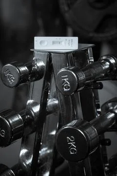 Negative Covid rapid test on the weights at a gym Stock Photos