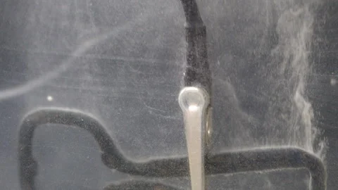 Negative electrical lead connected to metal part cleaned in electrolytic bath. Stock Footage 319628613