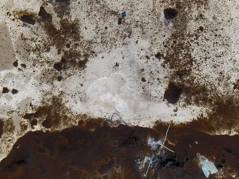 Negative image - Small hole in ice covering the pond surface in winter. Stock Photos