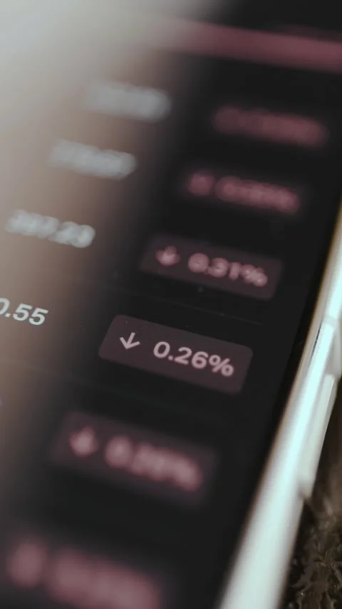 Negative percentage changes for various assets from a mobile trading application Stock Footage 329773657