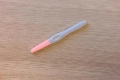 Negative pregnancy test over the table. Stock Photos