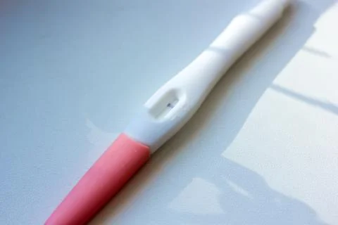Negative pregnancy test on white table. Stock Photos