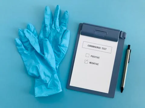 Negative result of coronavirus test chart and blue medical gloves with pen Stock Photos