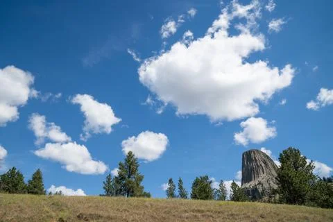 Negative space composition of Devils Tower, with a big blue summer sky with c Stock Photos