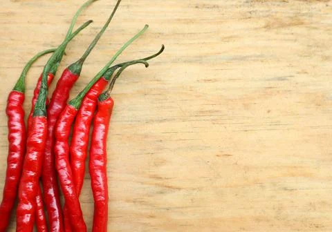 Negative space, red cayenne pepper or cabai rawit merah on a wooden cutting b Stock Photos