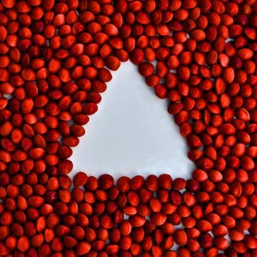 Negative space white triangle on red background Stock Photos