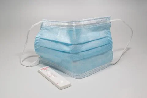 Negative test for COVID-19 blue protective medical face .mask on a white Stock Photos