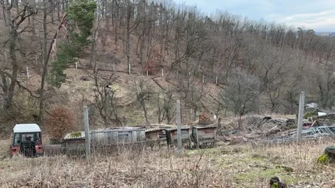 Neglected Plot Of Land With A Broken Old Tractor. Junk In The Garden. Stock Footage 264141575