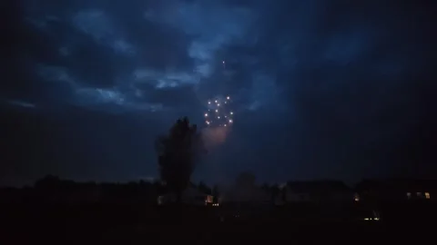 Neighborhood fireworks exploding in the night sky to celebrate America 250 Stock Footage 340115530