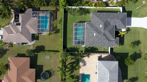 Neighborhood- flyby topdown backyard pool homes Cape Coral- Stock Footage 156828402