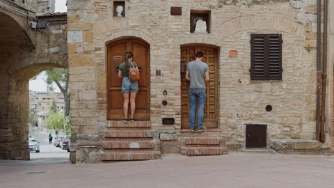 Neighbors guy, girl together close doors, walk down, collide and meet each other Stock Footage