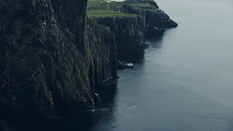 Neist point lighthouse on the cliffs Isle of Skye, Scotland, tilt up Stock Footage 91831638