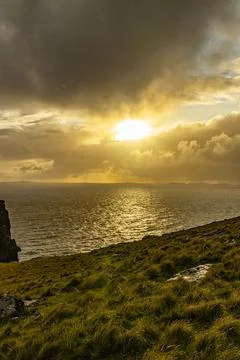 Neist Point at sunset, lighthouse, dramatic cliffs. Isle of Skye Stock Photos