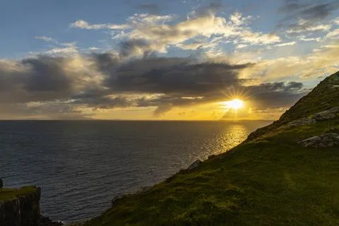 Neist Point at sunset, lighthouse, dramatic cliffs. Isle of Skye Stock Photos