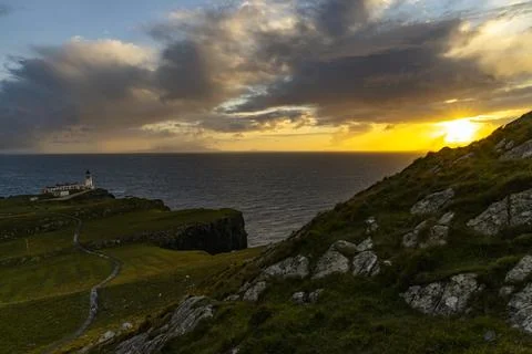 Neist Point at sunset, lighthouse, dramatic cliffs. Isle of Skye Stock Photos