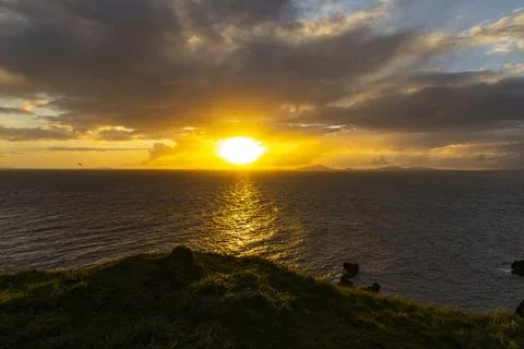 Neist Point at sunset, lighthouse, dramatic cliffs. Isle of Skye Stock Photos