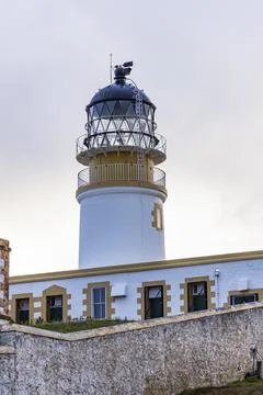 Neist Point at sunset, lighthouse, dramatic cliffs. Isle of Skye Stock Photos