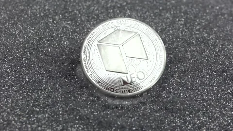 NEO cryptocurrency falls on silver sequins. Stock Footage 155544132