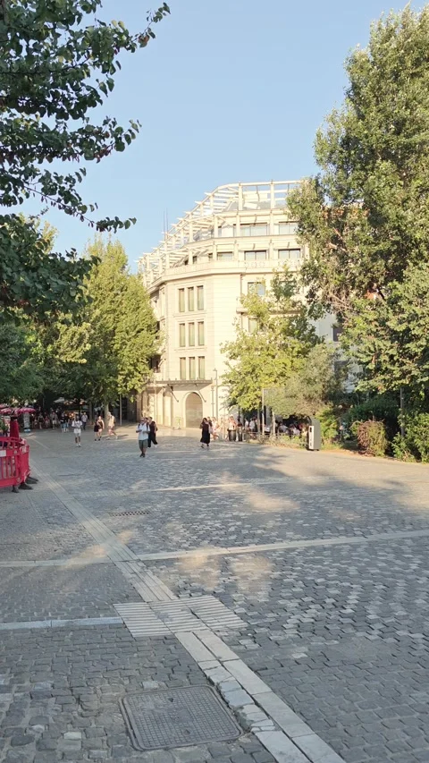 Neoclassical Building and Trees on a Cobbled Pedestrian Street, Athens, Greece Stock Footage 348437546