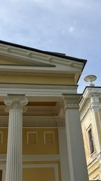 Neoclassical building exterior with ionic column capital, decorated pediment 库存照片