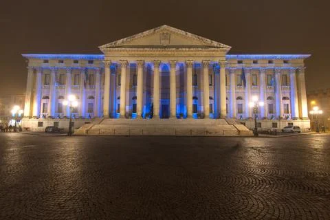 Neoclassical Building With Grand Columns Illuminated in Blue at Night Over .. Stock Photos