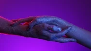 Neon 70S Style Vivid Light. Two Male And Female Hands In Sparkles Letting Go Of Stock Footage