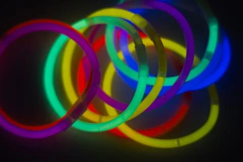 Neon bracelets glow sticks in the dark Stock Photos