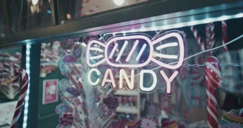 Neon candy sign illuminated inside market stall Video stock 325945041