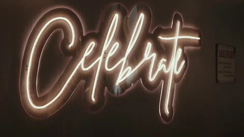 Neon celebration sign with glowing script and cross symbol Vídeo Stock 324939188