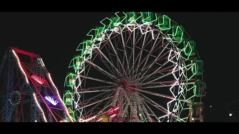Neon Ferris Wheel Motion Blur at Night Stock Footage 316579023