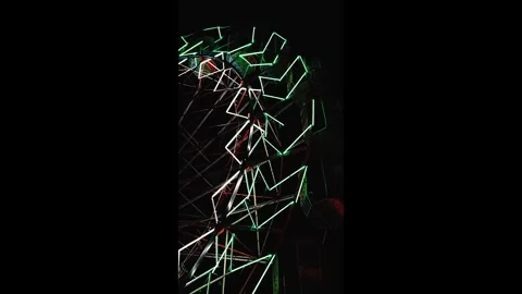 Neon Ferris Wheel Motion Blur at Night Stock Footage 316579033