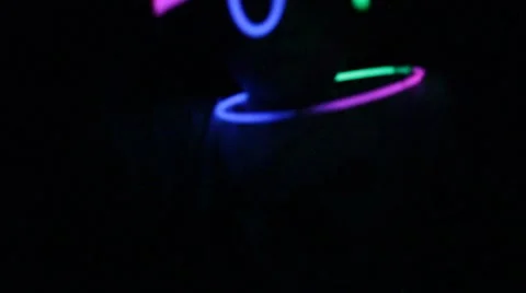 Neon glow sticks spin in the dark Stock Footage 40209378