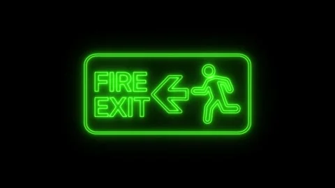 Neon green fire exit sign with glowing emergency signage on dark background. Stock Footage 345323710