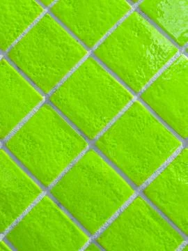 Neon green tiled wall pattern with textured glazed surface Stock Photos