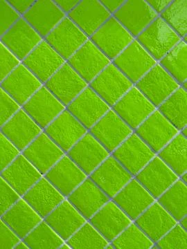 Neon green tiled wall pattern with textured glazed surface Stock Photos