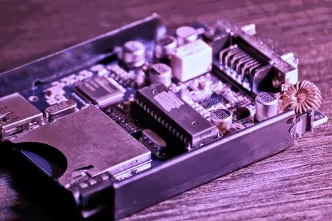 Neon highlighted PCB with a microchip on the engineer tabl Stock Photos