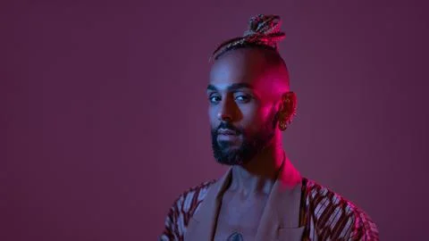 Neon light studio close-up portrait handsome black gay man looking camera. Foto stock