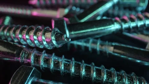 Neon lighting is reflected on the chrome surface of the screws. Parts for Stock Footage 159550269