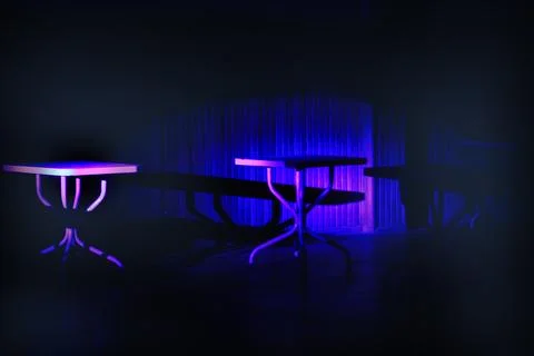 Neon-Lit Empty Tables in Darkness 스톡 사진
