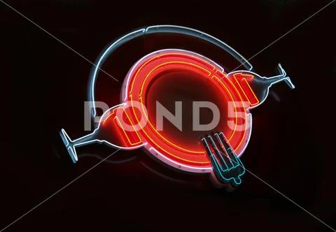 Neon luminous sign in the form of a plate of wine glasses Stock Photos