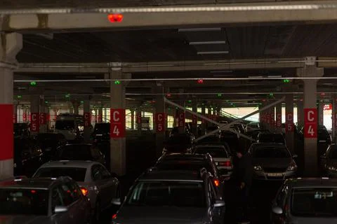 Neon multi-level underground parking in a shopping center. Fotos Stock
